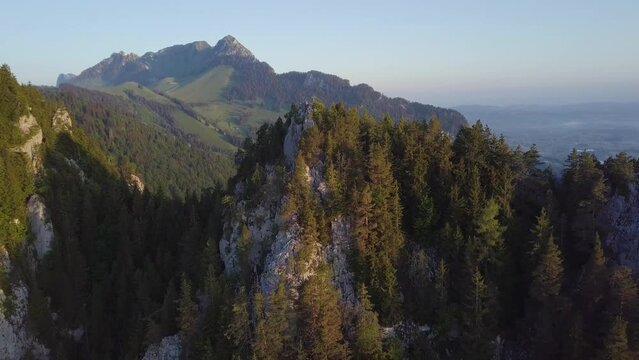 Sunrise behind a mountain peak in Switzerland filmed with a drone
