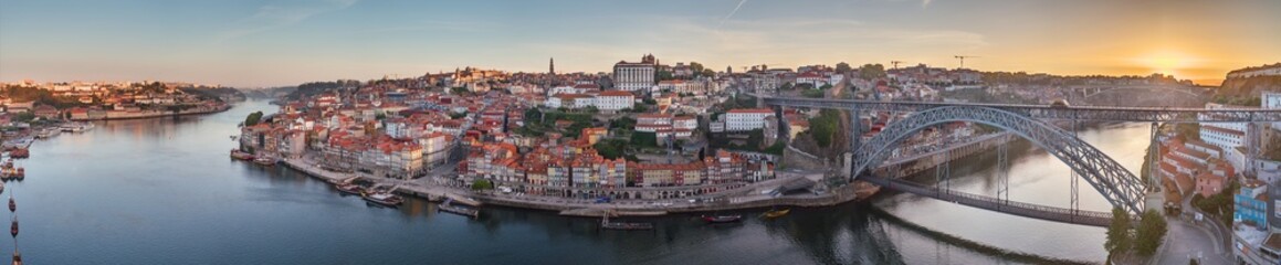 Naklejka na ściany i meble Drone panorama over the city of Porto and the Douro River at sunrise