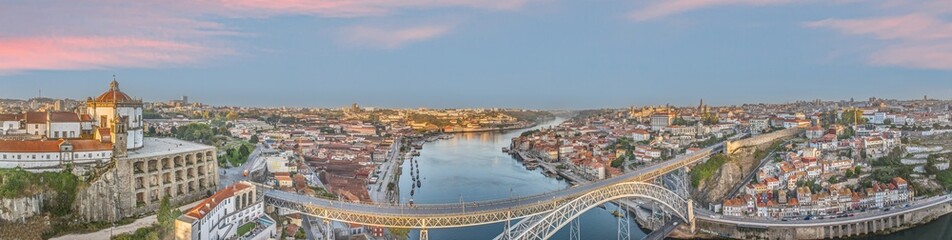 Fototapeta premium Drone panorama over the city of Porto and the Douro River at sunrise
