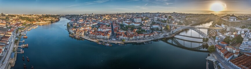 Naklejka na ściany i meble Drone panorama over the city of Porto and the Douro River at sunrise