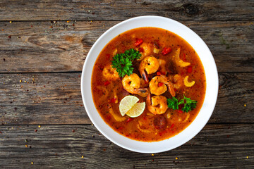 Louisiana soup gumbo with shrimp, chorizo and white rice on wooden table 