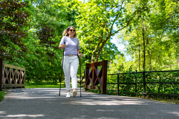 Nordic walking - woman exercising in city park