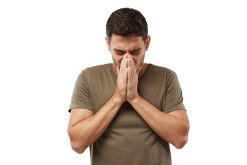 Sick young man covering face with hands, sneezing