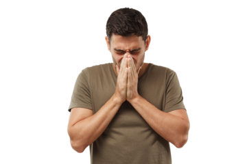 Sick young man covering face with hands, sneezing