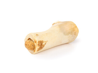 Isolated stuffed beef bone for dog chew fun and happiness. Long lasting medium real cattle bone. For dental health, mental enrichment  for dogs and puppies. Selective focus. White background.