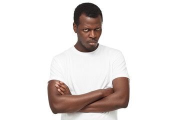 Angry african american man, evil black guy looking at camera with anger, standing with arms crossed
