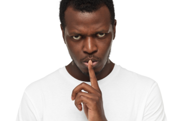 Close-up shot of angry african american man with shhh gesture, asking for silence or to be quiet