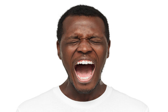 Close up portrait of screaming with closed eyes crazy african american man in blank white t-shirt isolated on gray background