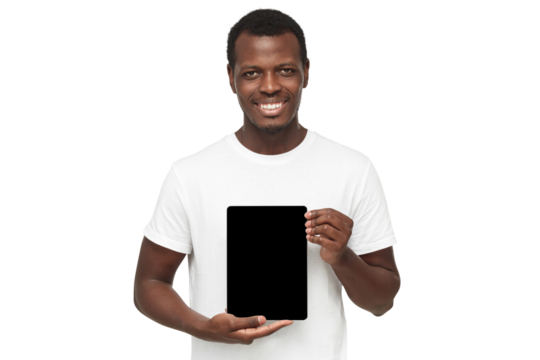 African american man standing in white t-shirt, holding tablet and showing vertical blank screen as mockup