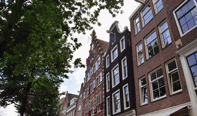 Fototapeta premium old buildings in the city, amsterdam alleys at spring