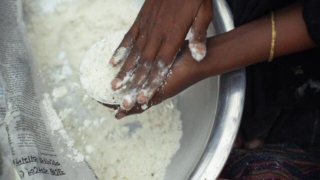 Making traditional rice cake called Bhapa Pitha, a soft and syrupy rice cake steamed to perfection, featuring coconut and jaggery for a deliciously sweet taste