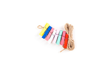 Wooden clips on a natural jute string for displaying photos