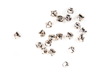 Scattered silver jingle bells isolated over white