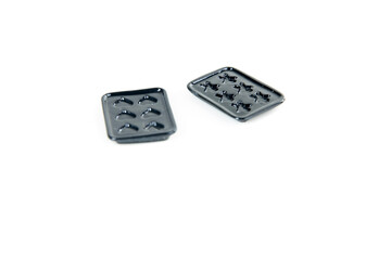 Pair of black toy muffin tins isolated over white