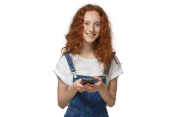 Portrait of curly redhead girl holding phone, looking at camera and smiling