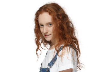 Side view of curly redhead girl biting lip, flirting, looking at camera