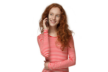 Young redhead curly woman talking on the phone