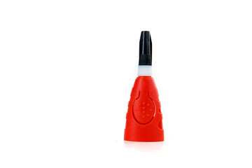 Red white and black glue bottle with the top on isolated over white
