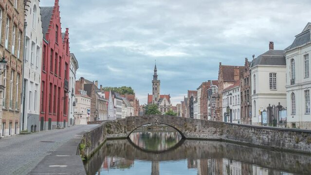 Bruges Belgium time lapse 4K, city skyline day to night timelapse at Spiegelrei Canal with King's Bridge (Koningsbrug)