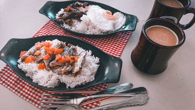 Sardine silog and tapsilog with coffee, two authentic traditional Filipino breakfast food from the Philippines