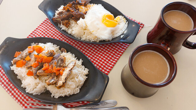 Sardine silog and tapsilog with coffee, two authentic traditional Filipino breakfast food from the Philippines