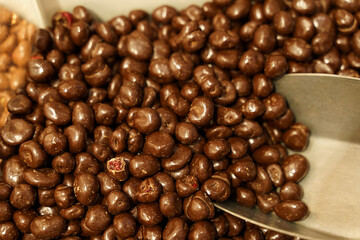 There are candies on the counter - chocolate-covered cranberries and a scoop.