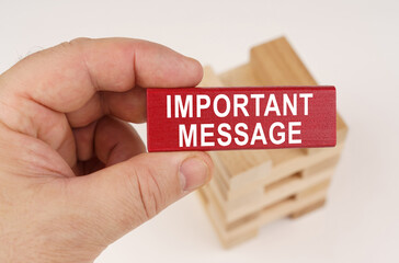 In the hands of a man there is a red wooden plate with the inscription - Important message