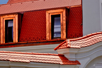 beavertail clay tile sloped residential roofs. bright shiny new copper plated roof dormers. new...