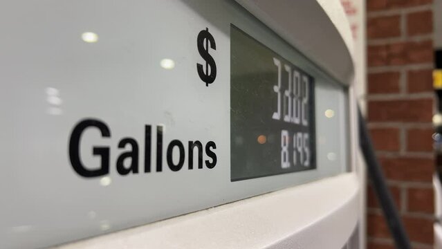 Gas station fuel meter counter price Close up of car refueling by increasing petrol costs. Wide shot footage