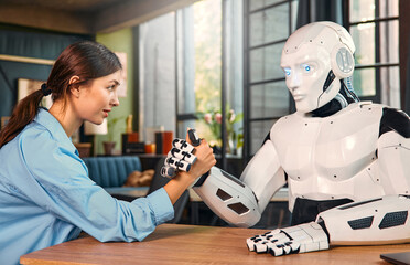 Robot and woman working on laptop in office