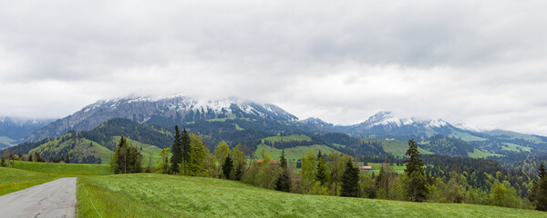 Panoramic view of Emmental valley with snowy mountains in canton Bern in Switzerland