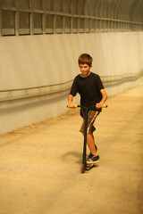 Portrait of eleven year old boy with a scooter