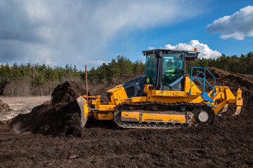 Modern bulldozer (crawler dozer) at work in the field. © Leszek Szelest