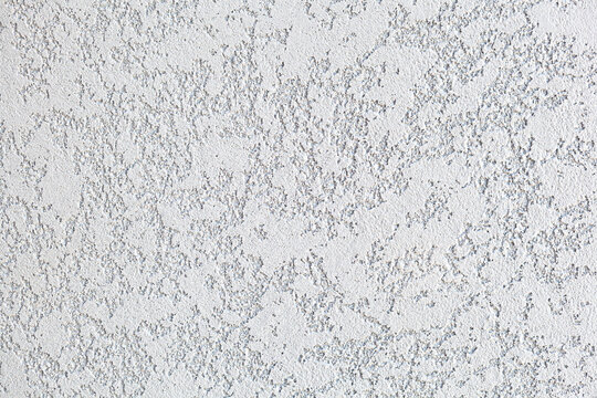 Light background of decorative plaster. Rough surface