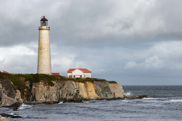 Seaside landscape with brick and old lighthouse in Eastern Canada