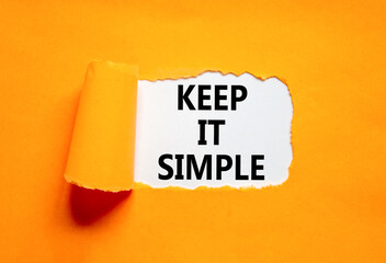 Keep it simple symbol. Concept word Keep it simple on beautiful white paper. Beautiful orange table orange background. Business motivational keep it simple concept. Copy space.