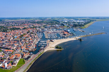 Drone photo of the former Zuiderzee island of Urk with beach harbors and old houses on a beautiful sunny day with cloudless sky - obrazy, fototapety, plakaty