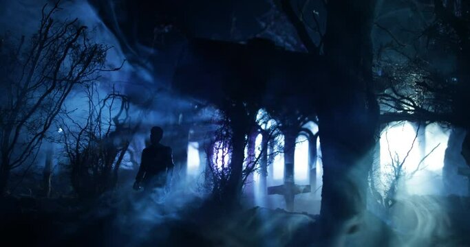 Silhouette of person standing in the dark forest with light. Horror halloween concept. strange silhouette in a dark spooky village