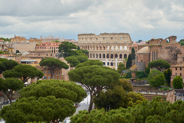 Fototapeta na wymiar View of roofs of Rome under cloudy sky.