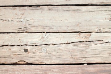 A collection of weathered and worn wooden boards, showcasing the character and history etched into their grain through years of use and exposure to the elements.