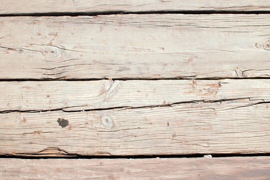 A collection of weathered and worn wooden boards, showcasing the character and history etched into their grain through years of use and exposure to the elements.
