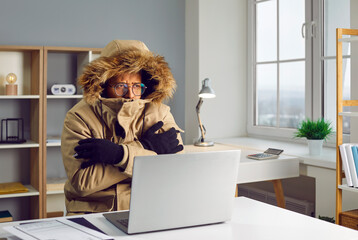 Portrait of a young african american business man in winter coat in the hood with gloves working in...