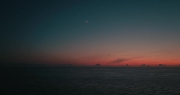 Sunset drone view of the moon on the ocean