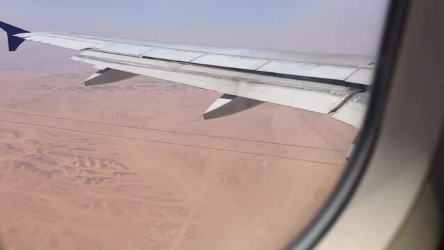 Aerial view of desert roads, captured from an airplane approaching Hurghada Airport in Egypt, through the left window.