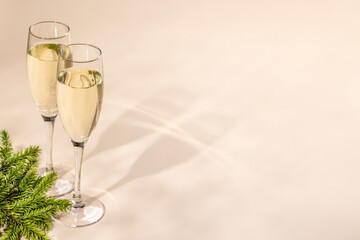 Two champagne glasses on a beige
