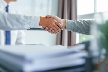 Lawyer consultant shaking hand with client in law firm..