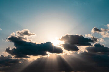 Silhouette of the clouds and sunrays at sunset.