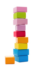Colorful blocks stacked high in a tower, ready to topple isolated