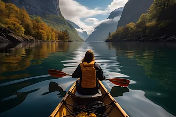 Foto op Plexiglas View from the back of a girl in a canoe floating on the water among the fjords. © MOUNSSIF