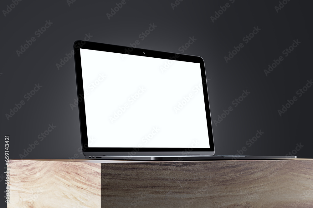 Poster close up of blank white laptop monitor on wooden surface and gray wall background. product presentat